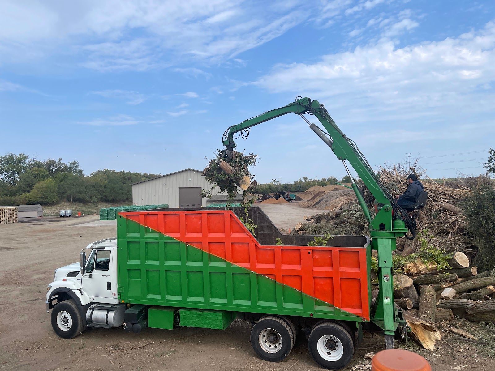 Bansai log loader truck loading logs and brush